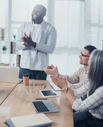 stock photo smiling multicultural colleagues clapping meeting creative agency